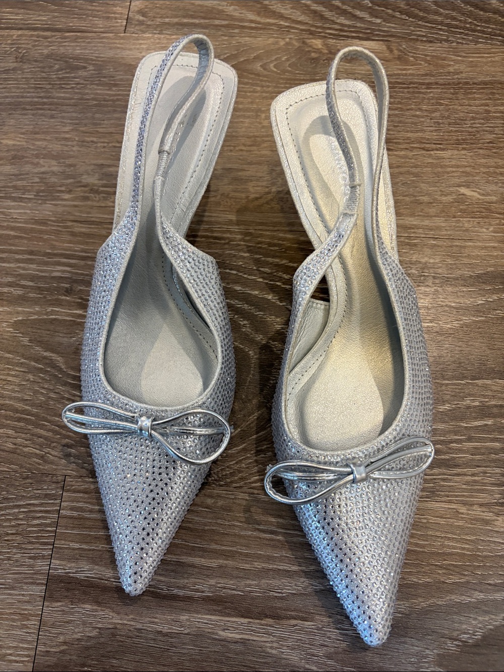Glamorous Silver Pointed Slingback Heels with Bow Accent